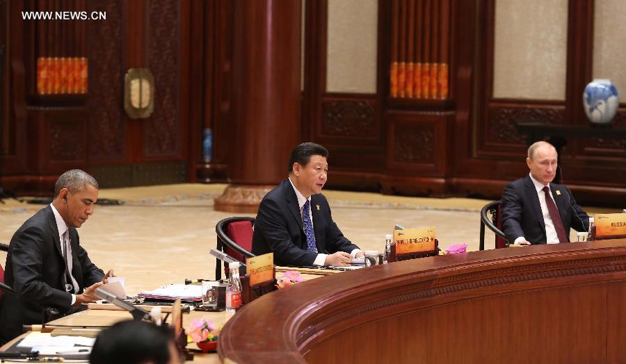 Chinese President Xi Jinping (C) hosts and addresses the 22nd Asia-Pacific Economic Cooperation (APEC) Economic Leaders